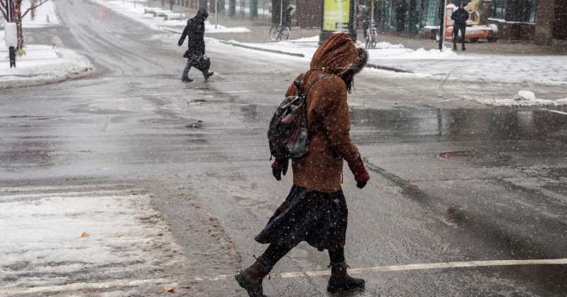 بارش برف در بعضی از نقاط کبک - فردی در حال گذشتن از خیابان برفی